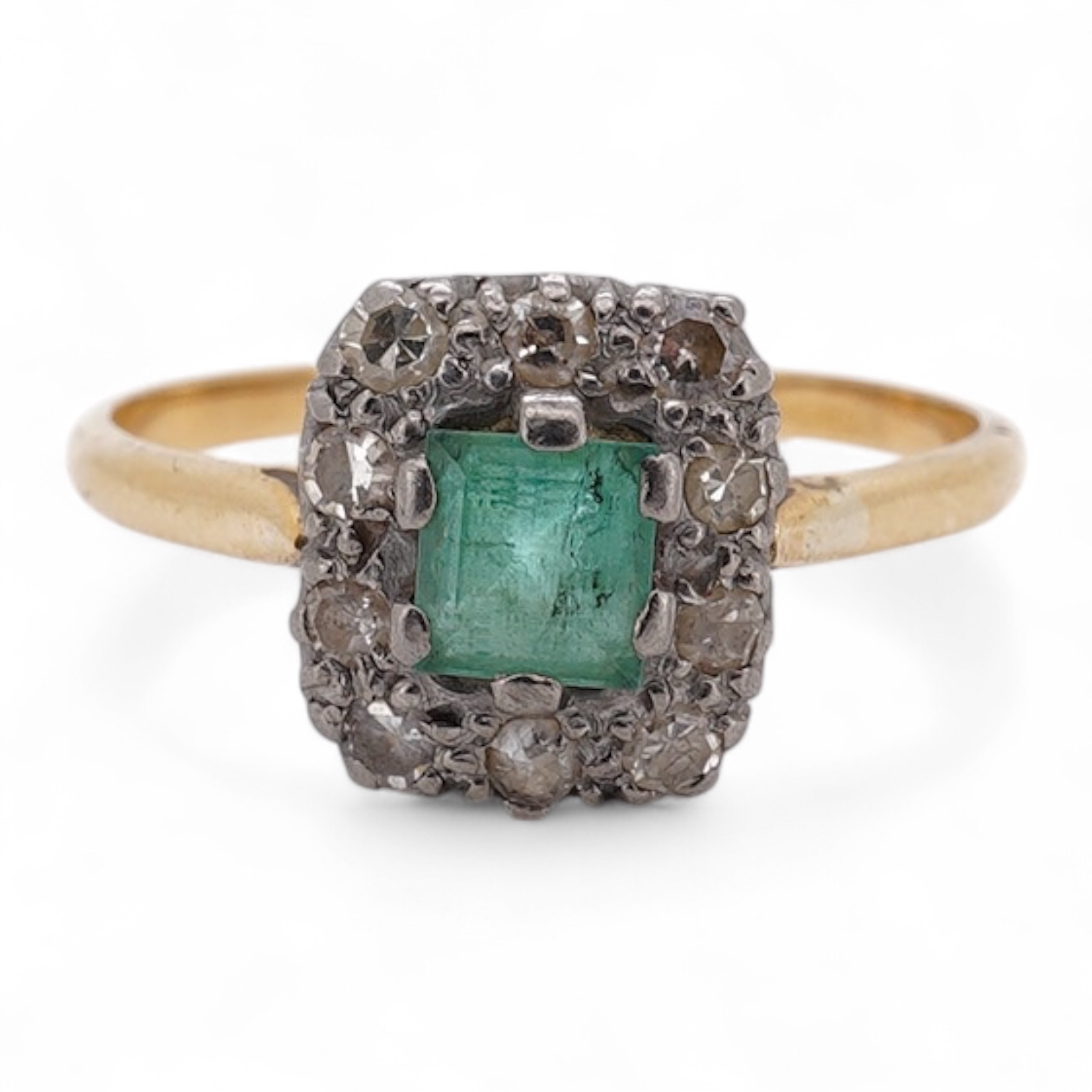 An early to mid 20th century yellow metal, emerald and diamond set rectangular cluster ring, size R, gross weight 3.5 grams. Condition - poor to fair